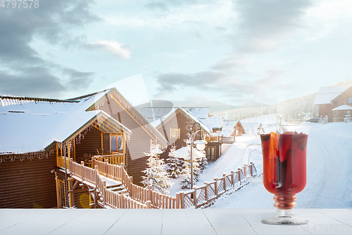 Image of Mulled wine and landscape of mountains on background