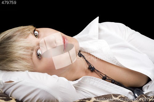 Image of portrait of the sexy young beauty blonde lies on a bed. Isolated