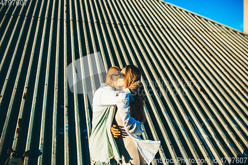 Image of Tanned young caucasian couple, modern lovestory in film grain effect