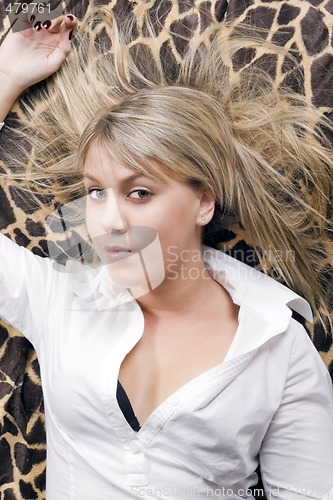 Image of portrait of the young beauty blonde lies on a bed