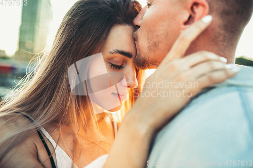 Image of Tanned young caucasian couple, modern lovestory in film grain effect