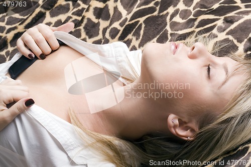 Image of emotional sexy young beauty blonde lies on a bed