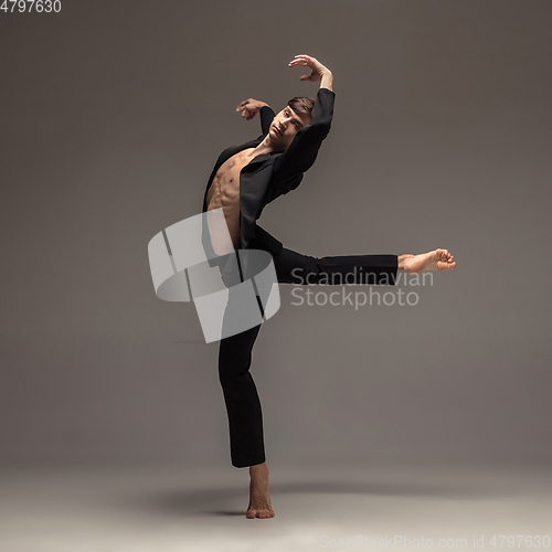 Image of Man in casual office style clothes jumping isolated on studio background