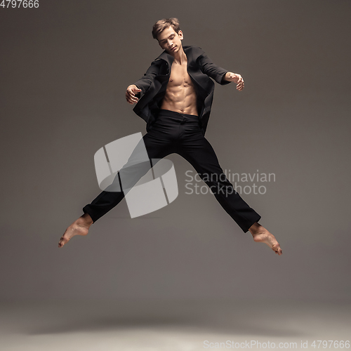 Image of Man in casual office style clothes jumping isolated on studio background
