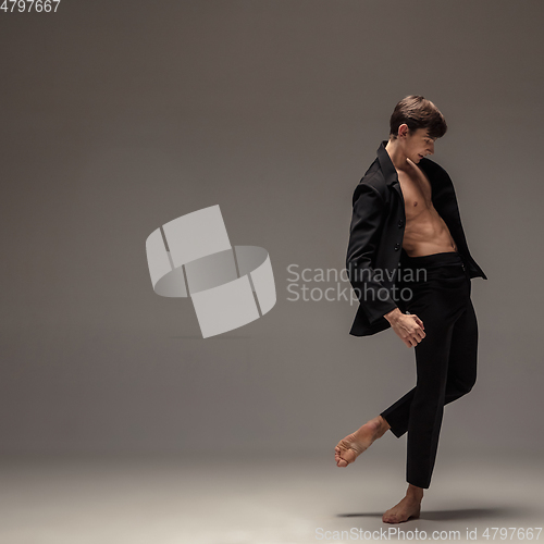 Image of Man in casual office style clothes jumping isolated on studio background