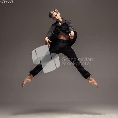 Image of Man in casual office style clothes jumping isolated on studio background