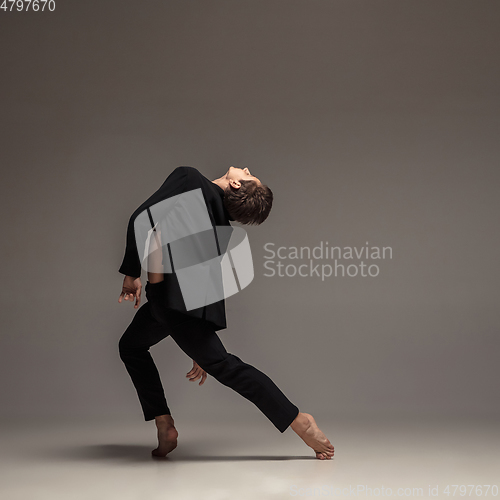 Image of Man in casual office style clothes jumping isolated on studio background