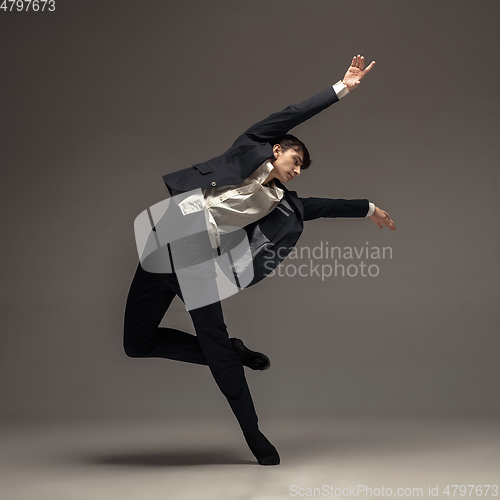 Image of Man in casual office style clothes jumping isolated on studio background