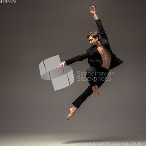 Image of Man in casual office style clothes jumping isolated on studio background