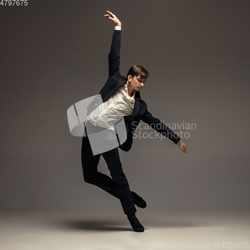 Image of Man in casual office style clothes jumping isolated on studio background