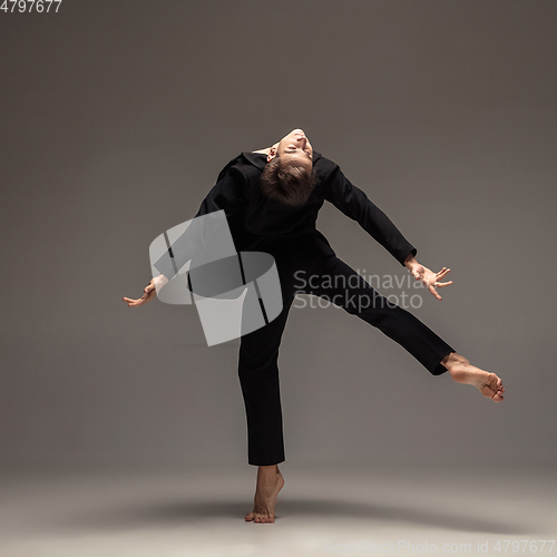 Image of Man in casual office style clothes jumping isolated on studio background