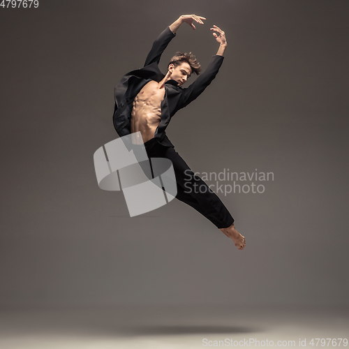 Image of Man in casual office style clothes jumping isolated on studio background