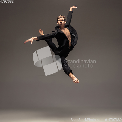 Image of Man in casual office style clothes jumping isolated on studio background