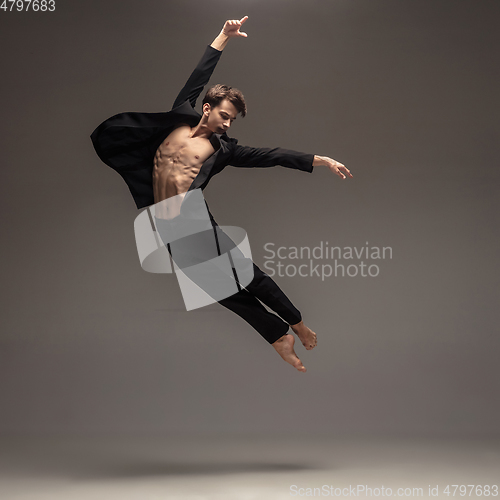 Image of Man in casual office style clothes jumping isolated on studio background