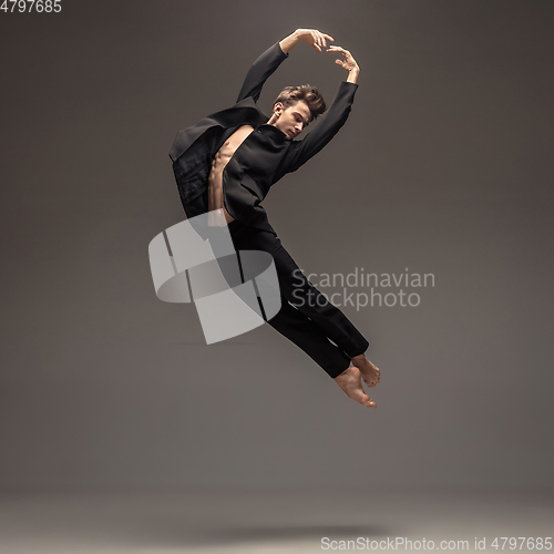 Image of Man in casual office style clothes jumping isolated on studio background