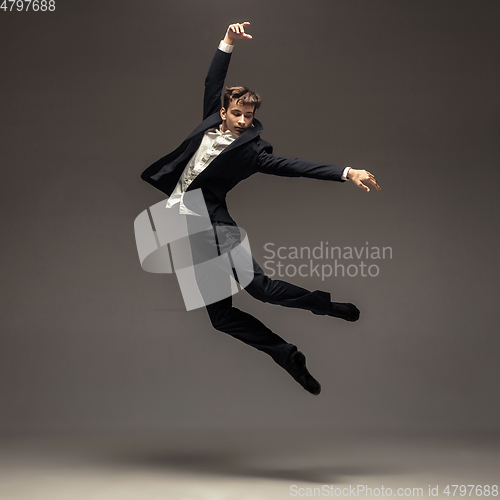 Image of Man in casual office style clothes jumping isolated on studio background