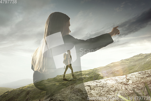 Image of Silhouette of businesswoman with landscapes on background, double exposure.