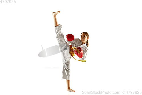 Image of Confident junior in kimono practicing hand-to-hand combat, martial arts