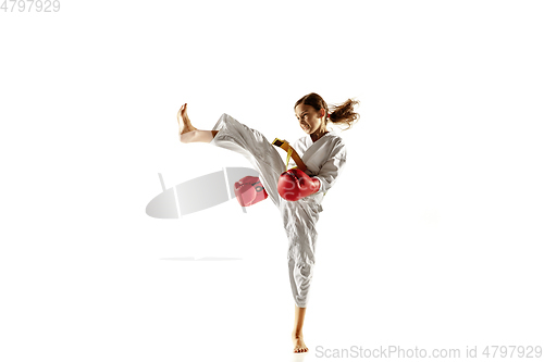 Image of Confident junior in kimono practicing hand-to-hand combat, martial arts