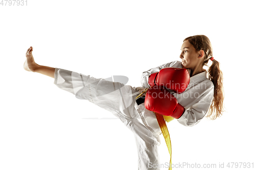 Image of Confident junior in kimono practicing hand-to-hand combat, martial arts