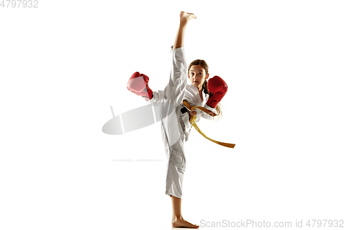 Image of Confident junior in kimono practicing hand-to-hand combat, martial arts