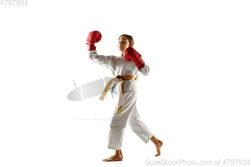 Image of Confident junior in kimono practicing hand-to-hand combat, martial arts