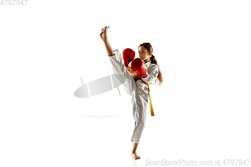 Image of Confident junior in kimono practicing hand-to-hand combat, martial arts