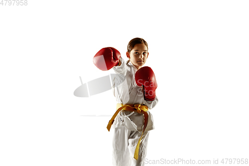 Image of Confident junior in kimono practicing hand-to-hand combat, martial arts