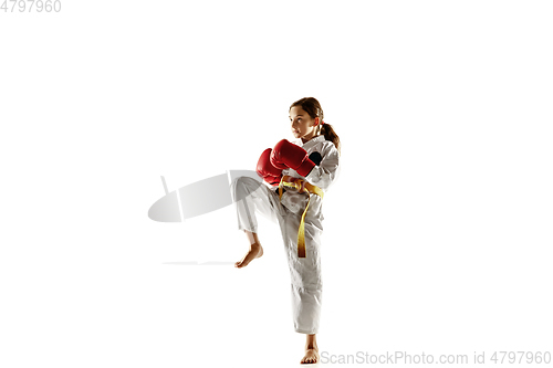 Image of Confident junior in kimono practicing hand-to-hand combat, martial arts