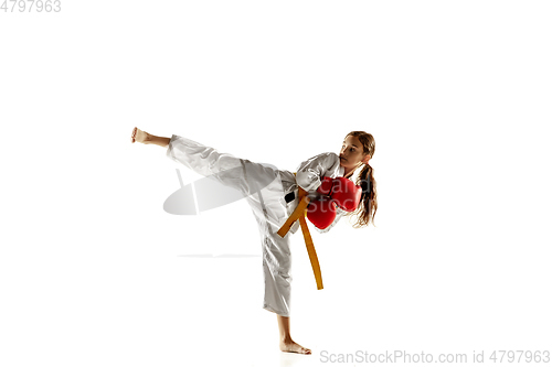 Image of Confident junior in kimono practicing hand-to-hand combat, martial arts