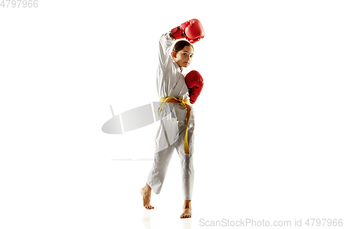 Image of Confident junior in kimono practicing hand-to-hand combat, martial arts