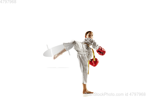 Image of Confident junior in kimono practicing hand-to-hand combat, martial arts