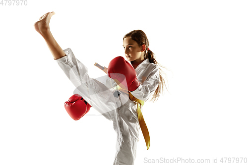 Image of Confident junior in kimono practicing hand-to-hand combat, martial arts