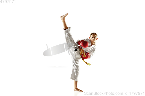 Image of Confident junior in kimono practicing hand-to-hand combat, martial arts