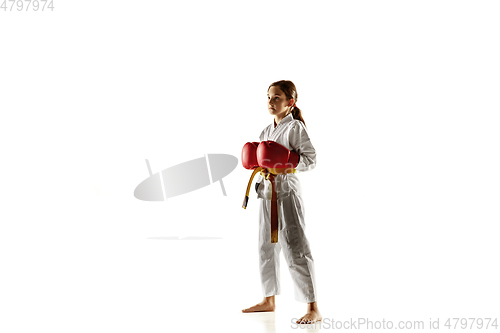 Image of Confident junior in kimono practicing hand-to-hand combat, martial arts