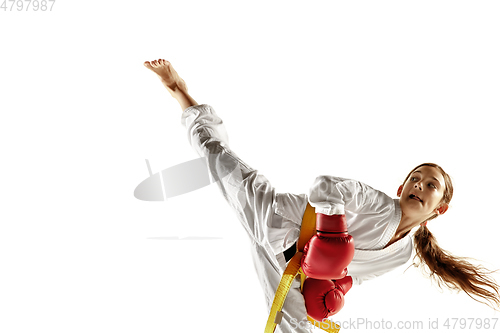 Image of Confident junior in kimono practicing hand-to-hand combat, martial arts