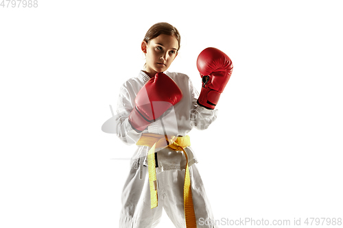 Image of Confident junior in kimono practicing hand-to-hand combat, martial arts