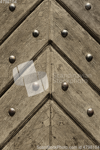 Image of Fragment of old wooden doors with metal rivets