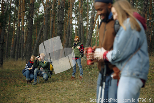 Image of Group of friends on a camping or hiking trip in autumn day