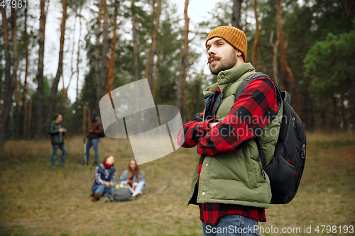 Image of Group of friends on a camping or hiking trip in autumn day