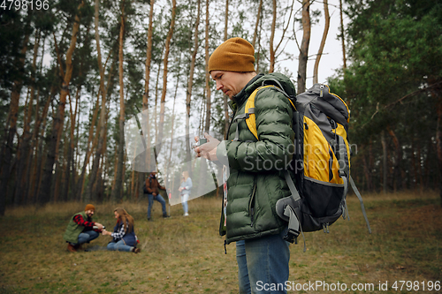 Image of Group of friends on a camping or hiking trip in autumn day