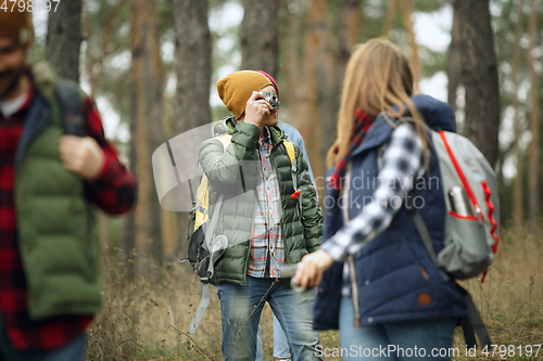 Image of Group of friends on a camping or hiking trip in autumn day