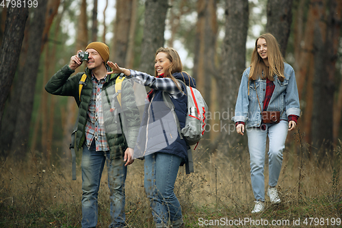 Image of Group of friends on a camping or hiking trip in autumn day