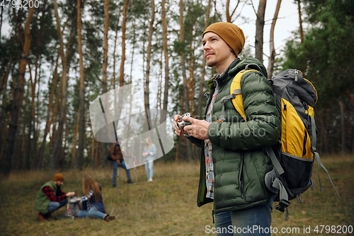 Image of Group of friends on a camping or hiking trip in autumn day