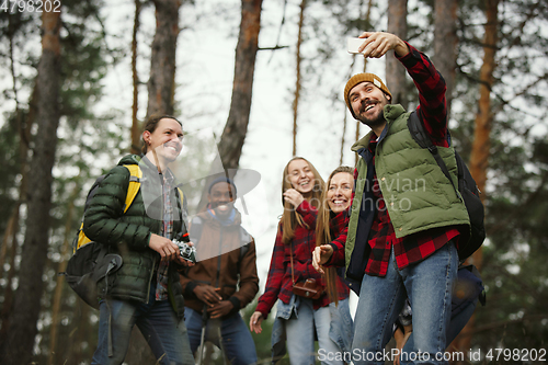 Image of Group of friends on a camping or hiking trip in autumn day