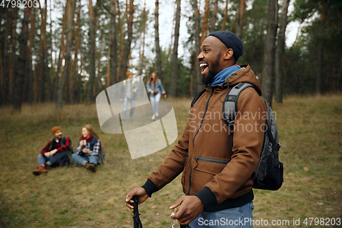 Image of Group of friends on a camping or hiking trip in autumn day