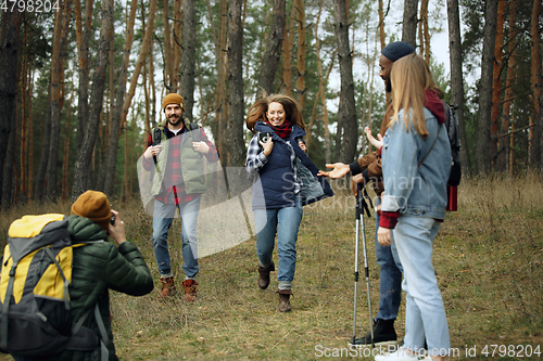 Image of Group of friends on a camping or hiking trip in autumn day