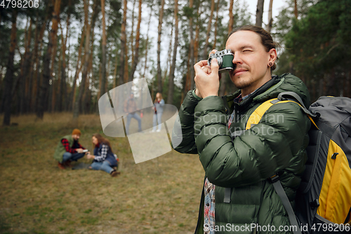 Image of Group of friends on a camping or hiking trip in autumn day