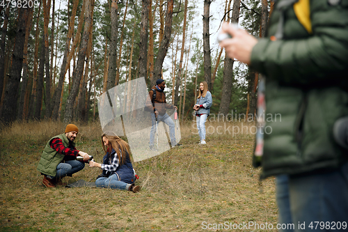 Image of Group of friends on a camping or hiking trip in autumn day