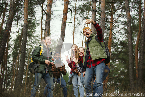 Image of Group of friends on a camping or hiking trip in autumn day